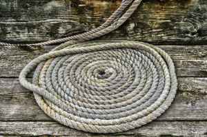 grey braided rope on wooden plank